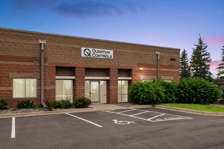 Exterior of Quantum Controls commercial building at twilight